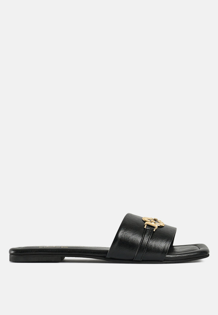 women metallic buckle embellished slip ons#color_black