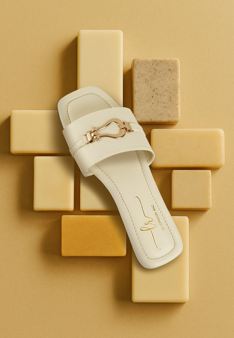 women metallic buckle embellished slip ons#color_off-white